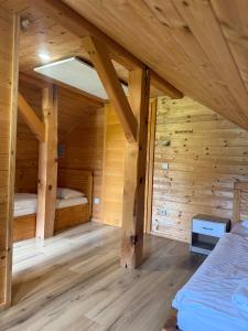 a room with two beds in a wooden cabin at Martinova izba - Family Bungalows in Laško