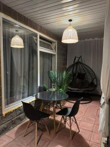 a patio with a table and chairs and a window at FishKa in Cholpon-Ata