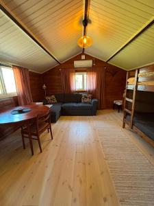 a living room with a couch and a table at Ugglan' in Undenäs