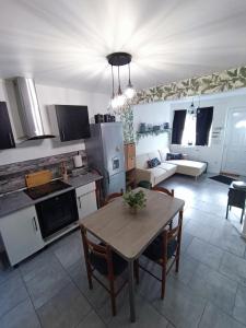 a kitchen and living room with a table and chairs at La Courée d'Orchies in Loos +13 photos