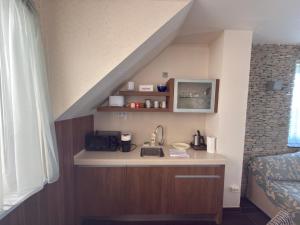 a kitchen with a sink in a room at Tihany Panoráma Apartman in Tihany