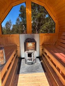 an inside of a wooden cabin with two windows at Ugglan' in Undenäs