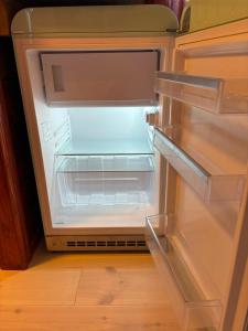 an empty refrigerator with its door open in a kitchen at Ugglan' in Undenäs +20 photos