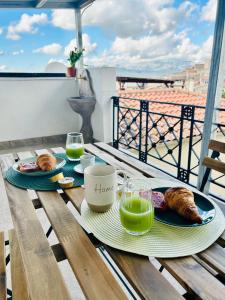 a table with two plates of food and drinks on a balcony at 'Na Scalunera in Mezzojuso