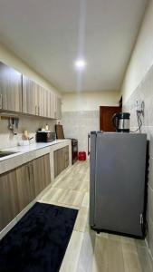 a kitchen with a stainless steel refrigerator in it at 2 Bedroom Apartment Kitengela in Kitengela 