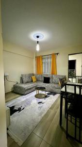 a living room with a couch and a table at 2 Bedroom Apartment Kitengela in Kitengela 