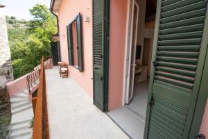 a door to the balcony of a house at OASI Apartment in Le Grazie