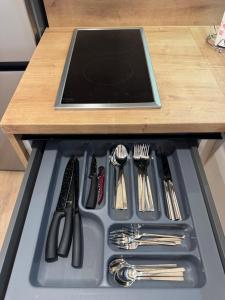 a drawer filled with utensils on top of a table at StanČapljina in Čapljina