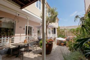 a patio with a table and an umbrella at Orotava The Home - Vacational rental with the lifestyle of 1700 and the comfort of 2022 in La Orotava