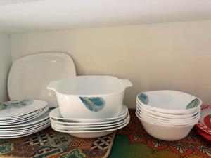two stacks of plates and bowls sitting on a table at Apparemment f3 délit Ibrahim in Deli Ibrahim