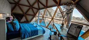 a room with a bed and a large window at Dôme Bao SPA luxe climatisé in Lesterps