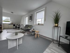 a living room with a couch and a table at Gemütliche Maisonette nahe Dinkelsbühl in Schopfloch