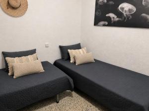 two beds sitting next to each other in a room at AMALIA 1 in L'Escala