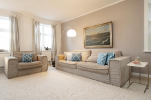 a living room with a couch and two chairs at Fischerhaus in Fehmarn