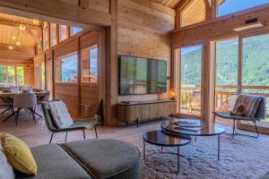 a living room with a couch and tables and windows at Jag Peak in Champcella