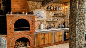 a kitchen with a brick oven and a sink at Best view house in Orşova