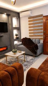 a living room with a couch and a table at MANDJOU résidence in Abidjan