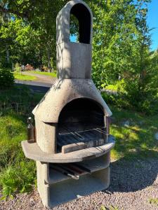 a stone oven sitting on the side of a road at Flamingon' in Undenäs