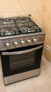 a stove top oven sitting in a kitchen at MANDJOU résidence in Abidjan