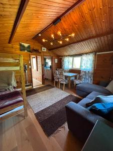a living room with a couch and a table in a cabin at Flamingon' in Undenäs