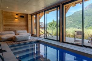 a house with a swimming pool and mountains at Jag Peak in Champcella