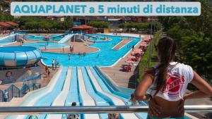 a woman is looking at a swimming pool at Casa Vacanze da Emanuela in Darfo