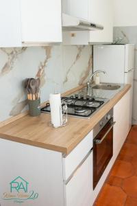 a kitchen with a stove and a sink at Roan Home Pompei 2 in Pompei +16 photos