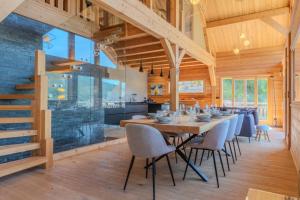a dining room with a long table and chairs at Jag Peak in Champcella