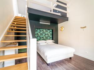a bedroom with a bed and a staircase at L' Homillon in Saubion