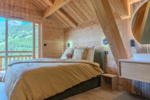 a bedroom with a bed and a large window at Jag Peak in Champcella +38 photos
