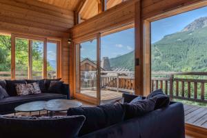 a living room with couches and a large window at Jag Peak in Champcella
