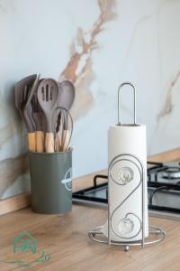 a container of kitchen utensils next to a stove at Roan Home Pompei 2 in Pompei