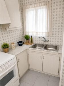 a kitchen with a sink and a window at AMALIA 1 in L'Escala