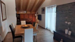 a dining room with a wooden table and chairs at Casa Moreschi in Tresivio