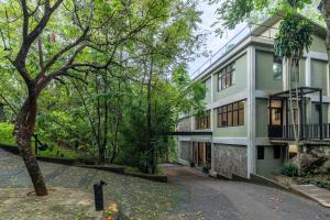 an exterior view of a house with trees at Serenique Resort Kandy in Kandy