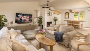 a living room with two couches and a table at Casa Tramonto I Peaceful Family House with garden, Veli Lošinj in Veli Lošinj +17 photos