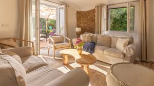 a living room with a couch and a table and chairs at Casa Tramonto I Peaceful Family House with garden, Veli Lošinj in Veli Lošinj