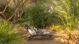 a bench sitting in the middle of a garden at Casa Tramonto I Peaceful Family House with garden, Veli Lošinj in Veli Lošinj