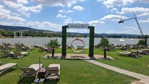 a sign for a wedding on a lawn next to a lake at Grand Hotel Residence Pieštany Adult only Boutique hotel Next to Wake Soul Beach in Piešťany