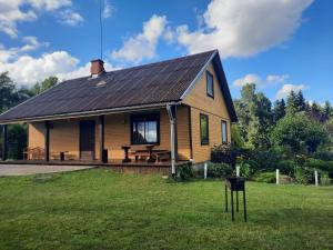 a house with a picnic table in the yard at Kļūda 3 in Biksinīki +21 photos