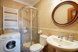 a bathroom with a toilet and a sink and a mirror at Casa Rural El Traspatio in Granadilla de Abona +60 photos