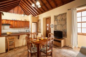 a kitchen and dining room with a wooden table at Casa Rural El Traspatio in Granadilla de Abona