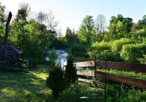 a garden with a fence and a river at Hnatowe Berdo BB in Wetlina +4 photos
