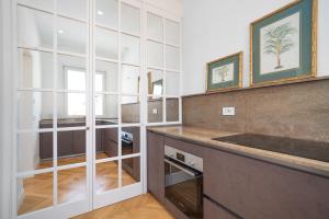 a kitchen with white cabinets and a counter top at Casa Lux Forte dei Marmi in Forte dei Marmi +12 photos