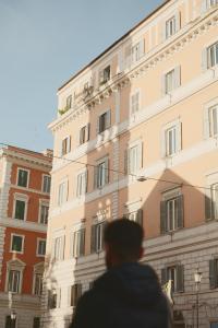 a man standing in front of a building at La Griffe Hotel Roma in Rome