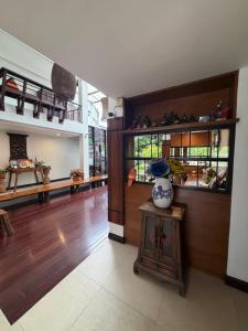 a living room with a vase on a table at Baan Ing Ping in Chiang Mai