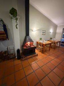 a fireplace in a room with a table and a dining room at Somer Place B&B in Somerset West