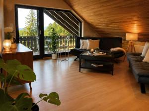 a living room with a couch and a table at Odw homes - naturnahe Wohnung im Landhaus in Trösel