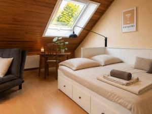 a bedroom with a bed and a window and a chair at Odw homes - naturnahe Wohnung im Landhaus in Trösel
