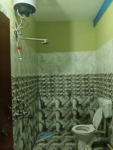 a bathroom with a shower and a toilet in it at Sharma Residency in Dithur